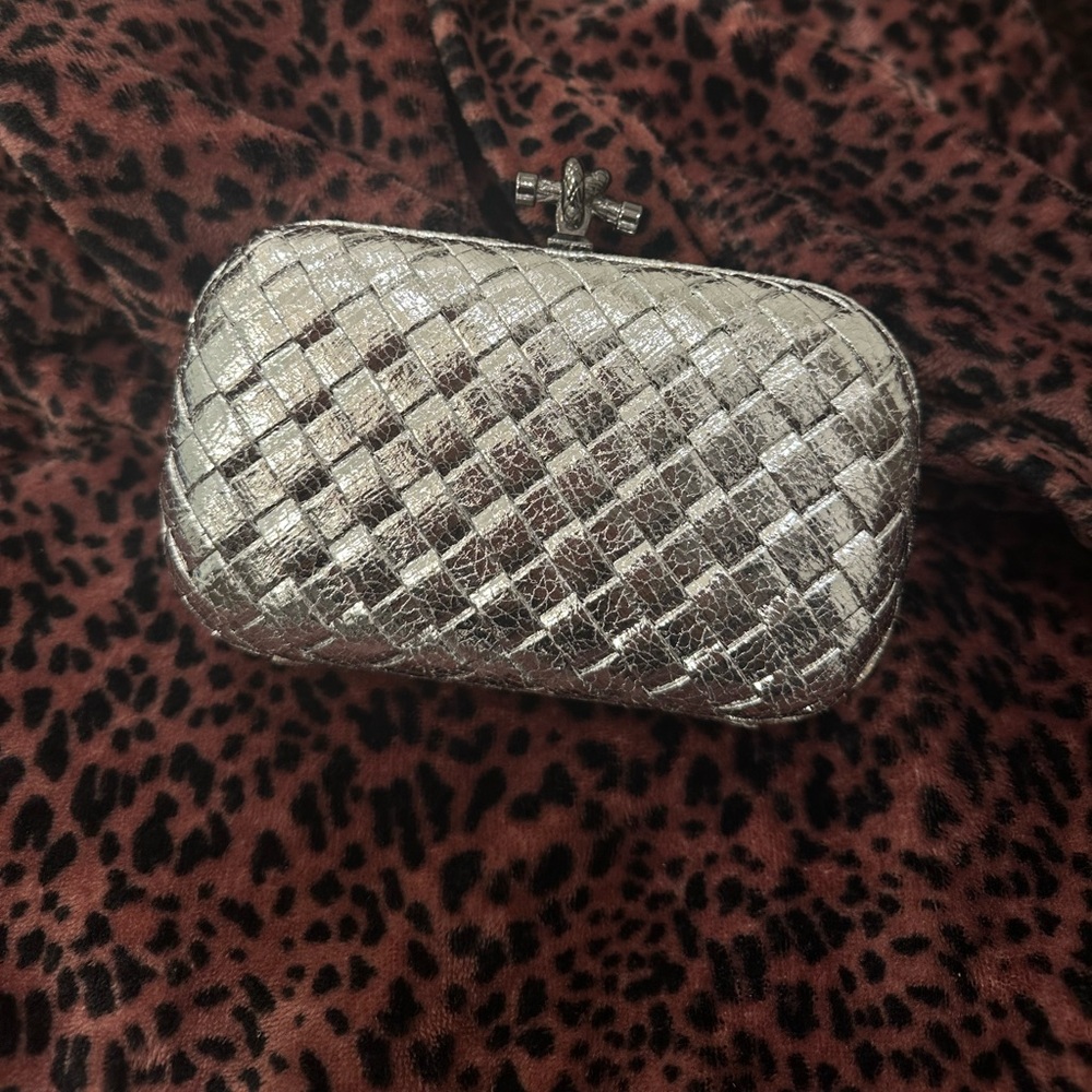 Womens silver knotted metallic clutch bag